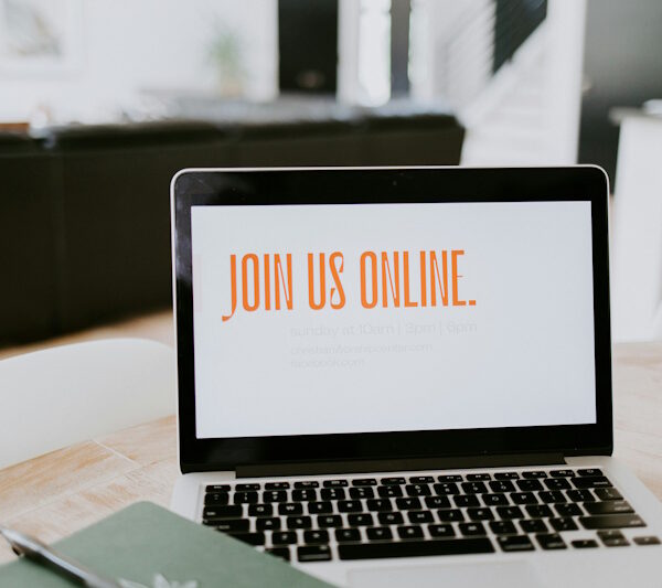Laptop displaying "JOIN US ONLINE" message, emphasizing online engagement for Mbvelo IT Consulting's services.